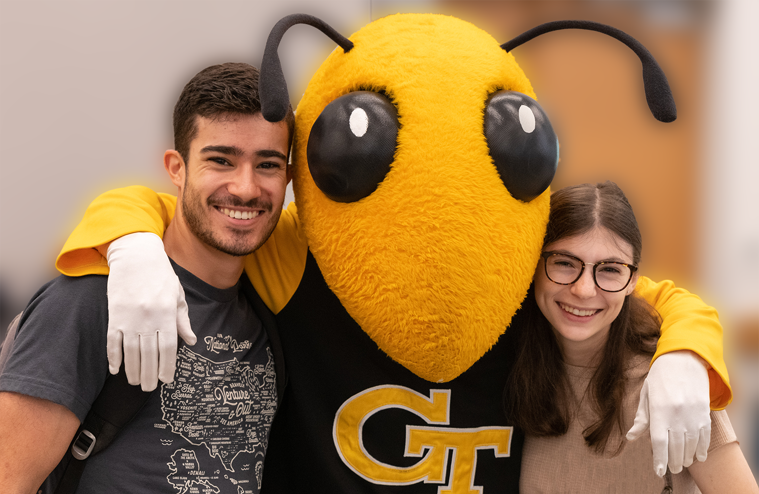 Buzz with a male and female Tech student.