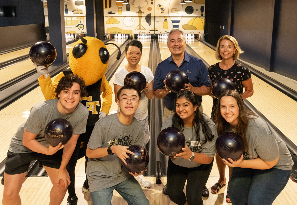 Buzz, Luoluo Hong, Angel and Beth Cabrera, and four Tech students pose with bowling bowls during the 22 Week of Welcome.