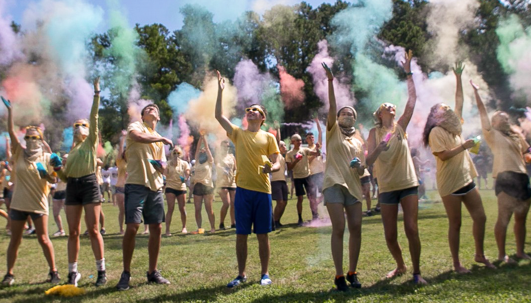 A group of Wreck Camp students surrounded by colored dust clouds.